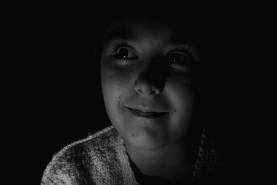 Close-up of girl looking away in darkroom