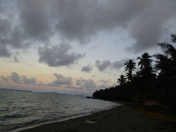 Scenic view of beach against sky during sunset