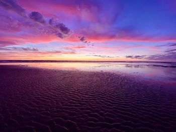 Scenic view of beach against sky during sunset