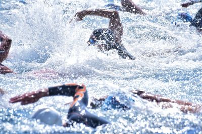 Men swimming in water