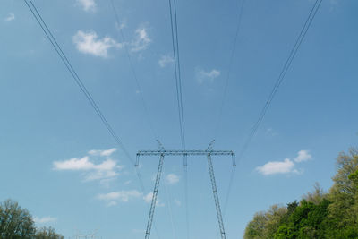 Low angle view of electricity pylon against sky