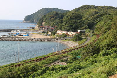 High angle view of sea and trees against sky