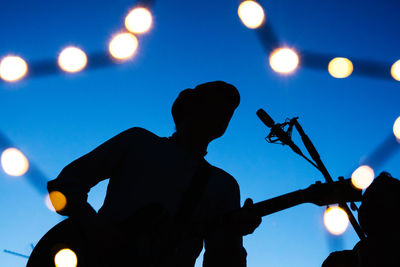 Low angle view of man playing guitar