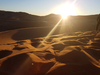 Scenic view of desert against sky during sunset