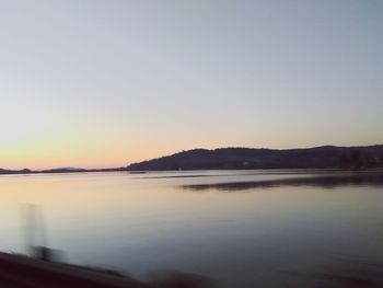 Scenic view of sea against clear sky during sunset