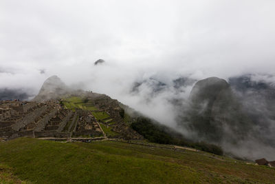 Scenic view of mountains against cloudy sky