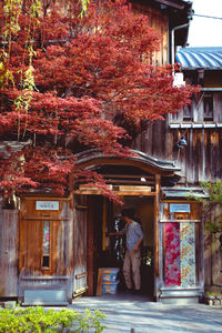 Rear view of man standing by building