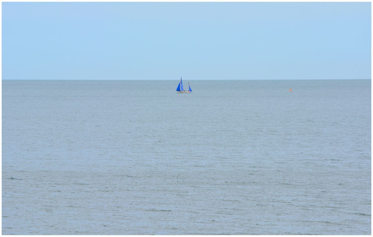 SCENIC VIEW OF SAILBOAT IN SEA AGAINST CLEAR SKY