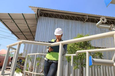 Mechanic engineer holding a note in the champagne bucket factory