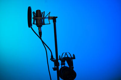 Low angle view of street light against clear blue sky