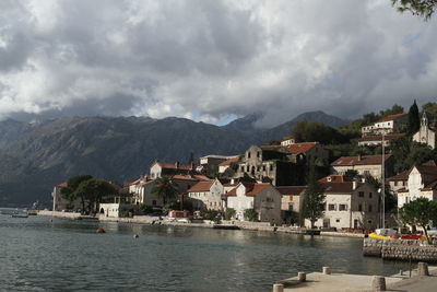 Buildings by town against sky