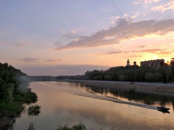 Scenic view of river against sky at sunset