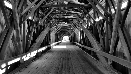 Low angle view of illuminated footbridge in tunnel