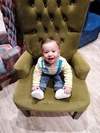 Portrait of cute baby boy on floor