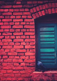 Brick wall with closed door of building