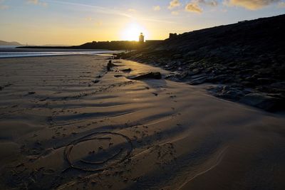 Scenic view of beach against sky during sunset