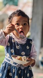 Portrait of girl eating food