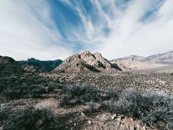 Barren landscape against clouds