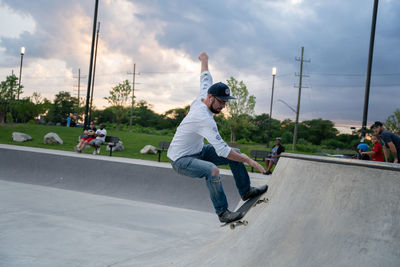 Man skateboarding on skateboard against sky