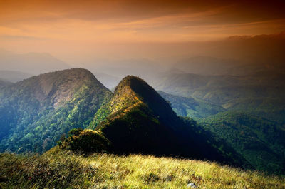 Scenic view of mountains against cloudy sky