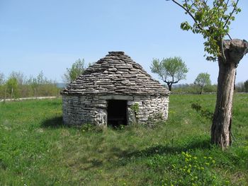 Built structure on field against clear sky