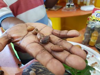 Midsection of man holding betel nut