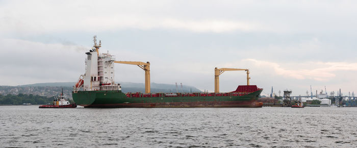 Commercial dock by sea against sky