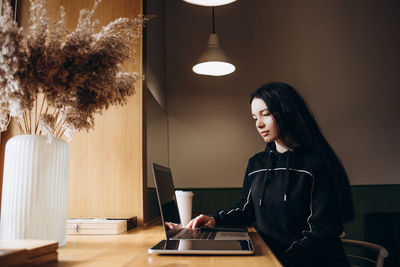 Young woman using laptop at home