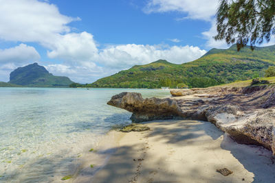 Scenic view of sea and mountains against sky