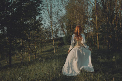 Woman with romantic dress walking in the countryside