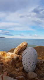 Close-up of rocks on beach against sky
