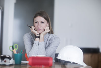 Young woman with long hair learning at home