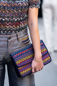 Midsection of woman standing outdoors