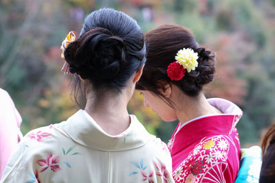 Rear view of women with flowers