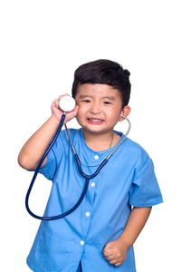 Portrait of smiling boy standing against white background
