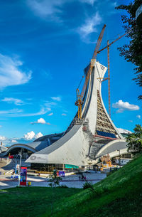 Low angle view of amusement park against blue sky