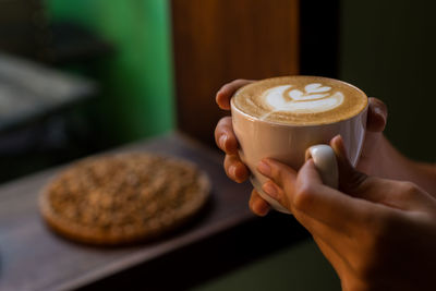 Close-up of woman holding coffee cup