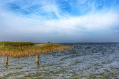 Scenic view of sea against cloudy sky