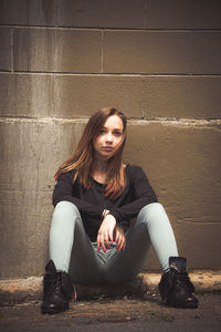 Portrait of teenage girl sitting outdoors