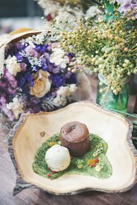 Close-up of flower bouquet with dessert in plate