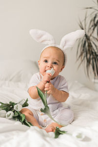 Portrait of cute baby boy sleeping on bed at home