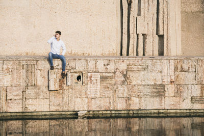 Full length of a man standing against wall