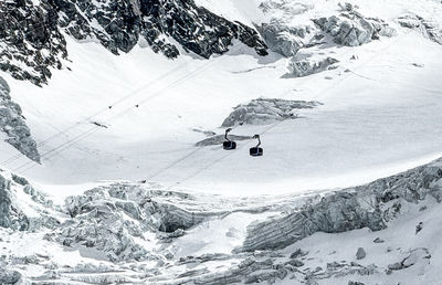 People skiing on snowcapped mountain