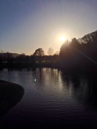Scenic view of river at sunset