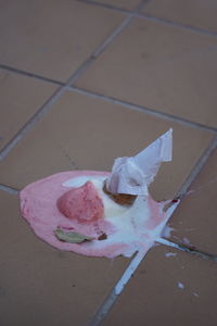 High angle view of pink cake on tiled floor