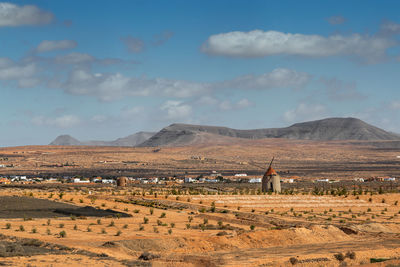 Scenic rural view of agricultural field against sky