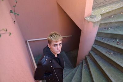 Portrait of man standing on staircase