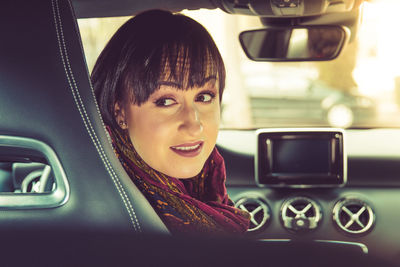 Woman in car looking back