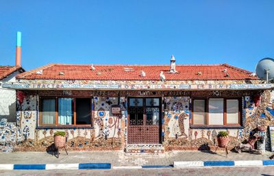 Exterior of old building against clear blue sky