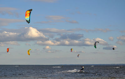 Man kiteboarding on sea against sky